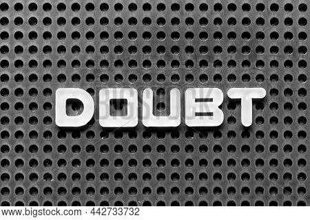 White Alphabet Letter In Word Doubt On Black Pegboard Background