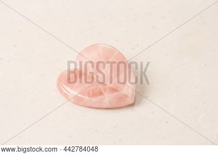 Natural Rose Quartz Heart Stone On Light Background. Natural Stones, Crystals For Magic, Lithotherap