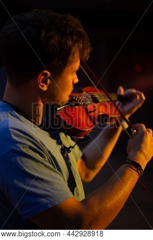 A Man Plays The Violin On The Stage Of Close