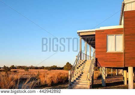 Sunrise on modern porch overlooking a beautiful landscape.