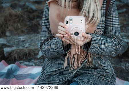 Close Up Of Female Hands With Pink Picture Camera  Instax