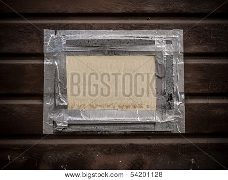 Blank white sign board framed by gaffer tape on wall background