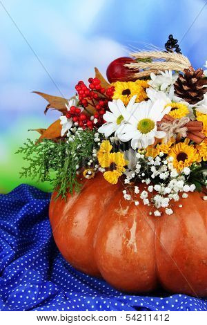 Beautiful autumn composition in pumpkin on table on bright background