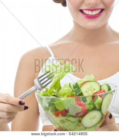 portrait of attractive  caucasian smiling woman isolated on white studio shot eating salat looking at camera