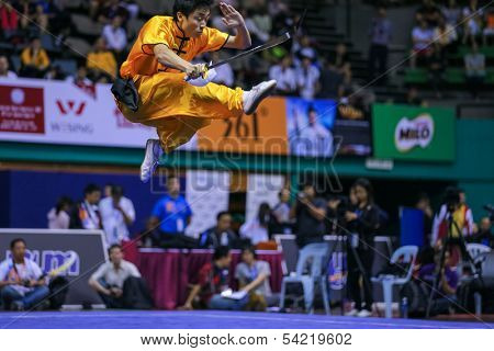 KUALA LUMPUR - NOV 03: Brazil's Henry Yuji Nakata executes a high kick in the Men's 'Daoshu' Event at the 12th World Wushu Championship on November 03, 2013 in Kuala Lumpur, Malaysia.