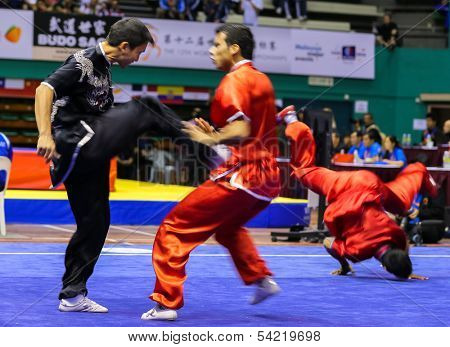 KUALA LUMPUR - NOV 05: Members of India's dalian team performs a fight scene in the Men's Dual Event at the 12th World Wushu Championship on November 05, 2013 in Kuala Lumpur, Malaysia.