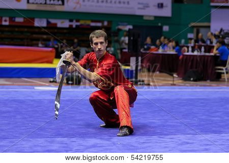 KUALA LUMPUR - NOV 03: Ukraine's Reva Roman performs with a sword in the Men's 'Daoshu' Event at the 12th World Wushu Championship on November 03, 2013 in Kuala Lumpur, Malaysia.