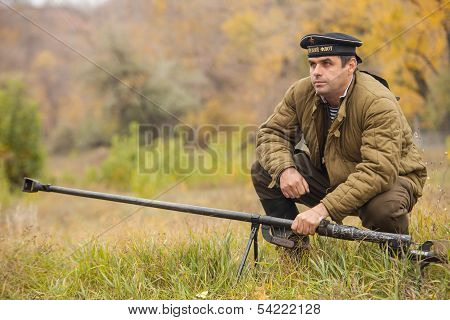 DNIPRODZERZHYNSK, UKRAINE - OCTOBER 26 : Member of battle Historical reenactment shows anti-tank gun
