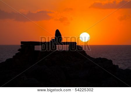 Ciutadella Menorca at Punta Nati orange sunset with girl backlight