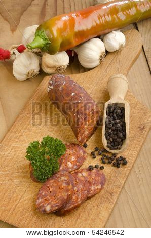 Sliced Hungarian Kolbasz On A Wooden Board