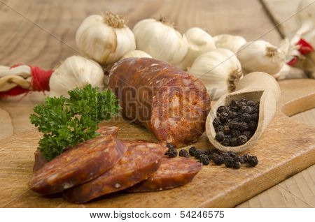 Sliced Hungarian Kolbasz On A Wooden Board