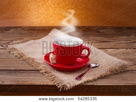 Coffee cup and saucer on  wooden table.