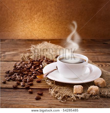 Coffee cup and saucer on  wooden table.