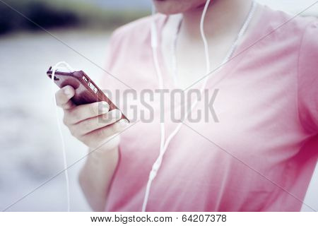 Young girl listening to music with retro filter effect