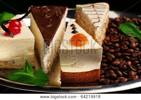 Assortment of pieces of cake, on dark background
