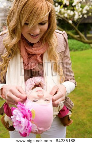 Young Mother And Baby Daughter Having Fum Outdoors