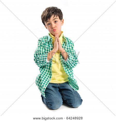 Brunette Boy Pleading Over Isolated White Background