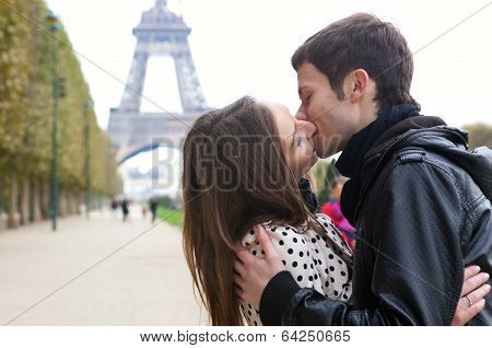 Young Romantic Couple Kissing Near The Eiffel Tower In Paris