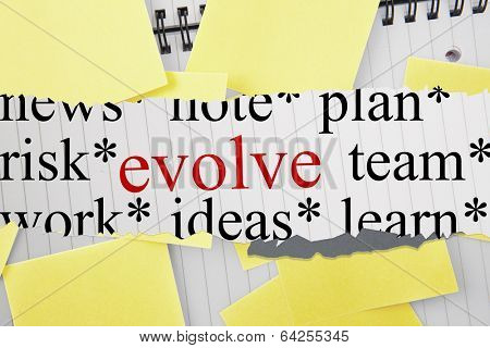 The word evolve against sticky notes strewn over notepad