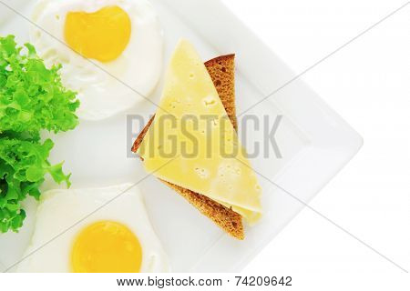 two fried eggs with salad bread and cheese