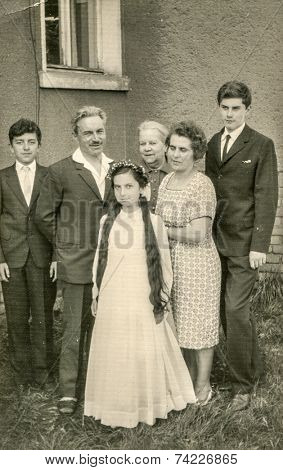 POLAND, CIRCA FIFTIES: Vintage photo of family with little girl at her First Communion