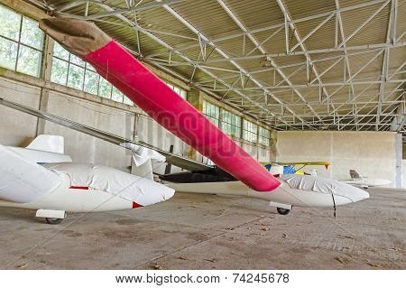 Lightweight Gliders Stationed Inside Of A Big Hangar