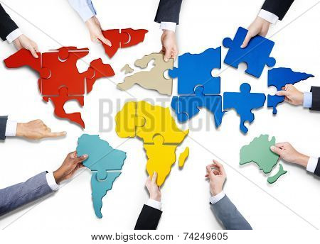 Group of Business People with Jigsaw Puzzle Forming in World Map