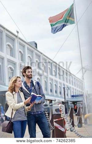 South Africa tourism couple with guide book on vacation holiday