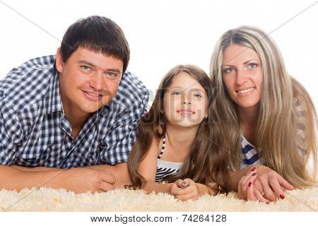 Happy family lying on a rug isolated on white
