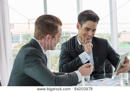 Two Businessman Dicussing Business In Office
