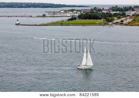 Sailboat And Motorboat Past Portland Lighthouse