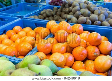 Various fruit in blue crates on market