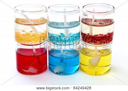 Candles In Glass In A Row On Top Of Each Other On A White