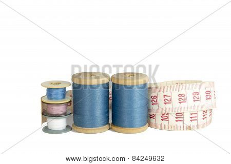Spools Of Thread With A Ruler Isolated Over White