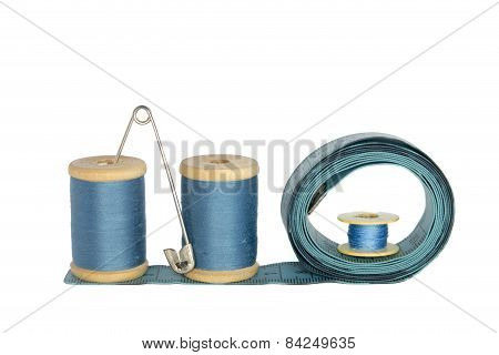 Spools Of Thread With A Ruler On A White Background