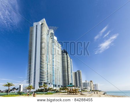 People Relax Near The Pier In Sunny Isles Beach