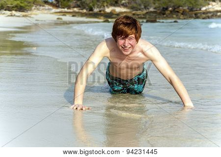 Boy At The Beautiful Beack Trains Push-ups