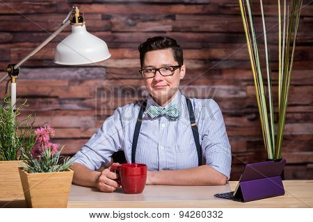 Dapper Woman In Stylish Office At Wood Desk With Mug