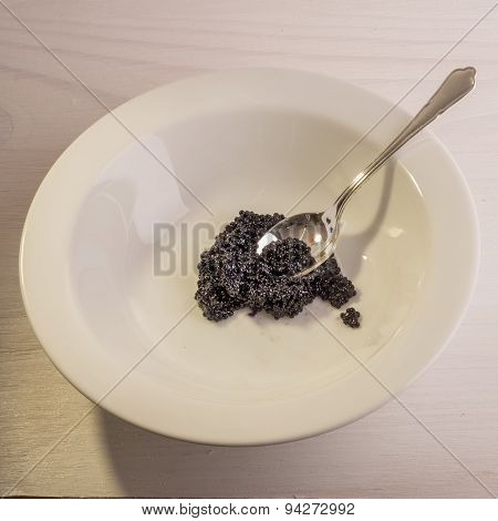 Silver Spoon And Caviar In White Bowl
