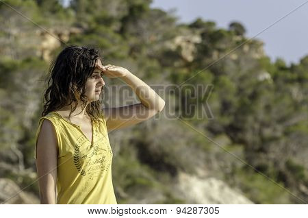 Girl With The Hand In Forehead And The Forest In The Background