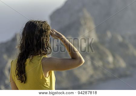 Beautiful Woman Looking Ahead With The Hand In Forehead And The Forest In The Background