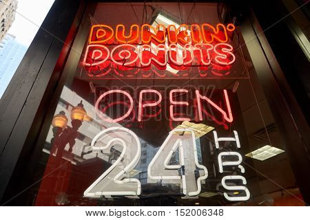 CHICAGO, IL - CIRCA MARCH, 2016: close up shot of Dunkin' Donuts open 24 hours sign. Dunkin' Donuts is an American global donut company and coffeehouse chain.