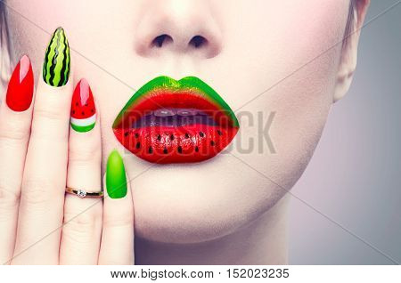 Trendy Watermelon summer or autumn Manicure and Lips. Beauty Fashion Makeup and Manicure. Glamour Nail Art and Make up closeup over gray background