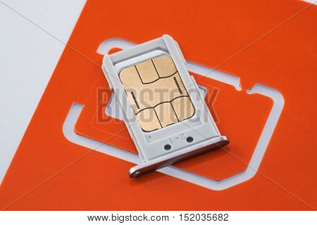 Nano sim card with sim tray and sim card adapter on white background