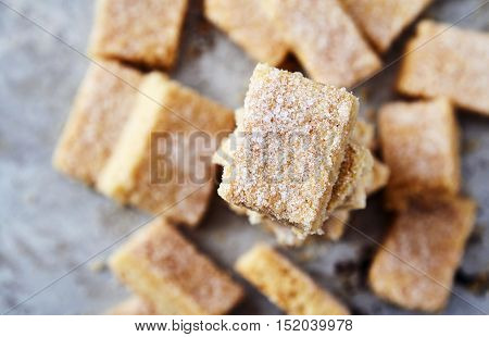 Delicious homemade sugar cookies made from semolina, butter, flour and sugar. Crumbly, delicate texture, the sugar crust on top. A little sweetness to the tea on gray background. Selective focus