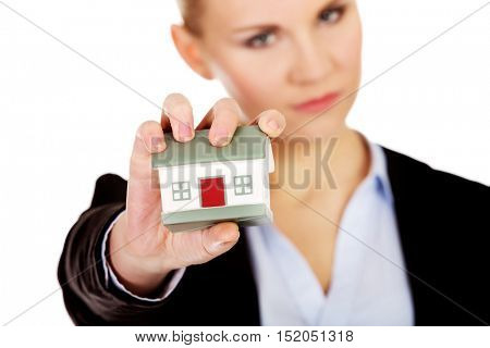 Aggresive business woman crushing small house