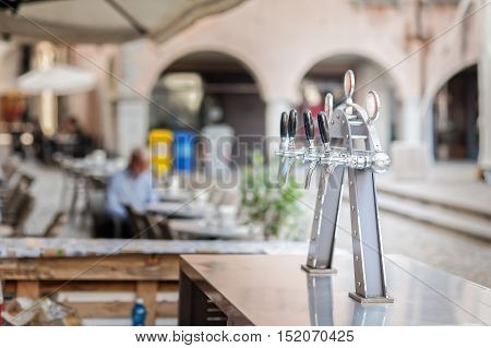 Draught beer taps and other beverages in a bar.