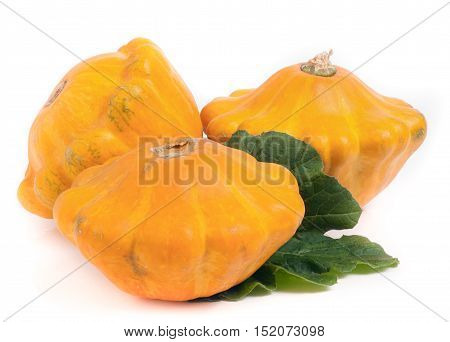three yellow pattypan squash with leaf isolated on white background.