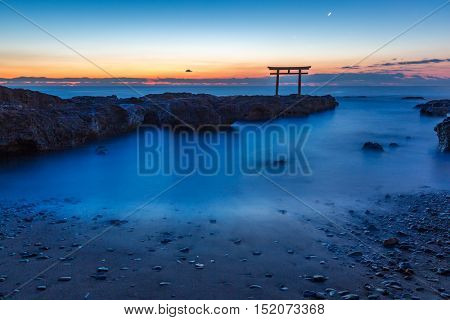 Toroii Japanese shrine gate sunrise at sea Oarai city , Ibaraki Japan