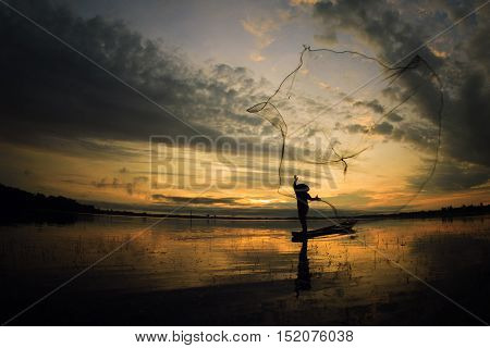 Fisherman fishing on a river fishing boat Thailand.